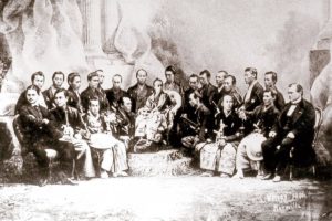 old, black and white photograph of a group of people in formal wear.