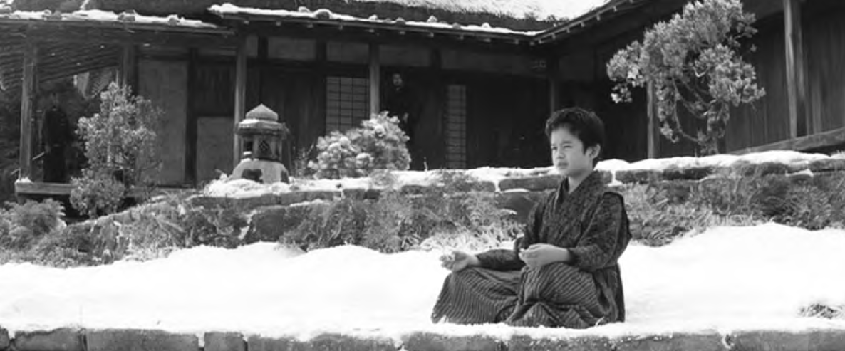 photo of a young boy meditating in the snow