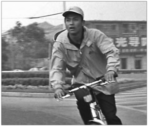 a boy rides his bike