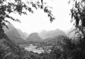 photo of lush mountains and a village at the base of them