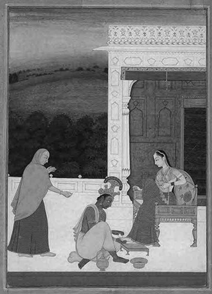 a woman's feet are attended to by two people