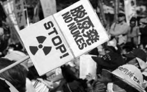 protest sign saying "no nukes, stop!"