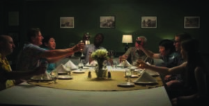 Picture of people raising their glasses at the dinner table