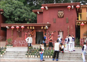 a photo of people standing outside a red and yellow building