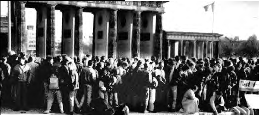 a large crowd stands in front of gates