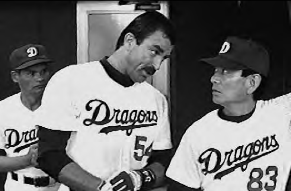 photo of three men in dragons baseball uniforms. One of the men is asian.