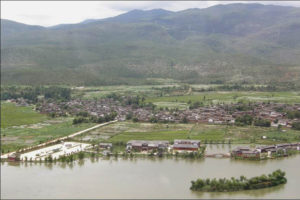 aerial photo of a tightly packed settlement next to water