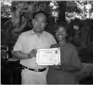 a photo of two people posing with a diploma