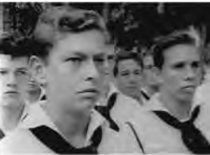 several young men stand in sailor uniforms