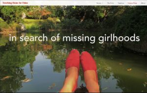 A photo of women's feet wearing red shoes in front of a serene pond. Text is layered on top which says "in search of missing girlhood."