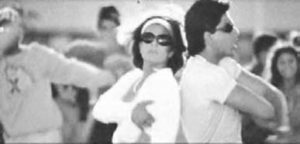 a man and woman in white t shirts and goggles stand back to back and arms crossed