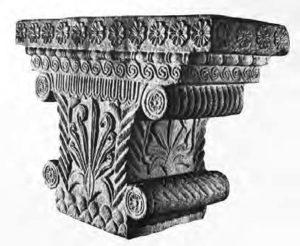 photo of an intricate top of a pillar, with lots of swirls and leaf imagery