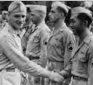Roy Uyehata receiving a congratulatory handshake by other military men.