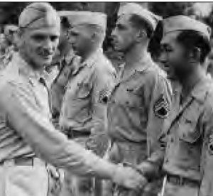 Roy Uyehata receiving a congratulatory handshake by other military men. 