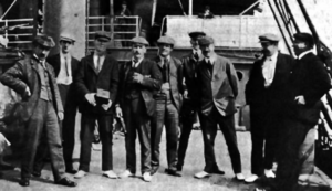 A photo of nine man standing on the steamship