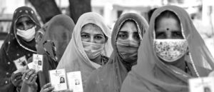 a photo of several women in shayla holding voter ID cards