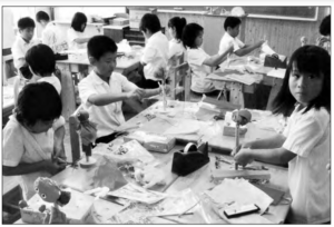 Photo shows students are doing arts task in the classroom