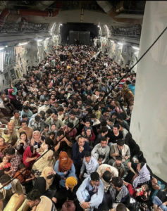 a photograph of a corridor, which is filled completely with people.