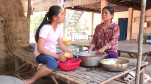 A Cambodian woman being interviewed by her daughter.