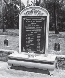 photo of a grave with twelve names engraved on the plaque