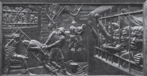 a carved relief of people behind bars and being tortured and detained