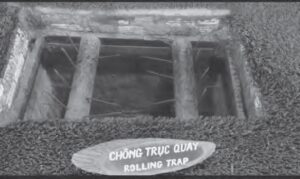 photo of a rolling trap, which has logs covered in long metal spikes