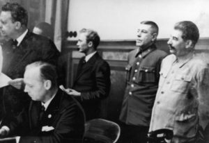  A historical photograph capturing Joseph Stalin and Joachim von Ribbentrop, along with other German and Russian officials, standing and sitting during the signing of the German-Soviet Boundary and Friendship Treaty. The scene represents a significant moment in history, symbolizing the diplomatic relations and agreements between Germany and the Soviet Union during that time.
