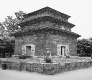 photograph of a three-tiered building with lions guarding the entrances on each side.