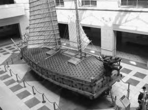 a photograph of a wooden ship with sails in a museum