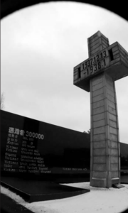 A sculpture of a cross with the date of  the massacre.