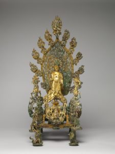 altar with a buddha figure and a teardrop shape behind him