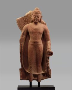 a standing buddha statue that is slightly broken