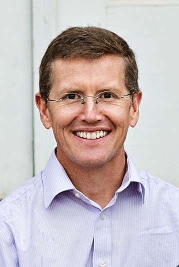 photo of a smiling white man with glasses