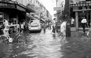 People walking on a shopping street with heavy ground water