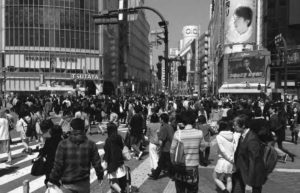 Shibuya Scramble Crossing (渋谷スクランブル交差点, Shibuya sukuranburu kōsaten), commonly known as Shibuya Crossing, is a popular pedestrian scramble crossing in Shibuya, Tokyo, Japan.[1] It is located in front of the Shibuya Station Hachikō exit and stops vehicles in all directions to allow pedestrians to inundate the entire intersection. The statue of Hachikō, between the station and the intersection is a common meeting place, which is almost always crowded.Three large video screens mounted on nearby buildings overlook the crossing, as well as many static advertising signs. The Starbucks store overlooking the crossing is one of the busiest in the world. Given its heavy traffic and amount of advertising, it is compared to Times Square in New York City and Piccadilly Circus in London.