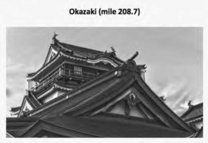 photo of a temple, focused on the pointed roofs.