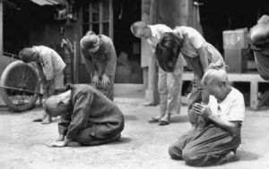 a group of people bowing