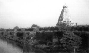 The Tanjore Temple with surrounding moat. "This monumental granite temple reaches a height of 212 feet, and its walls are covered with greater than life-sized carvings of the Gods and Goddesses."