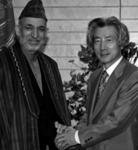 Image of two people shaking the hand, left to right,  Mr. Hamid Karzai, the President of the Islamic Republic of Afghanistan and Prime Minister Junichiro Koizumi 