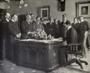 John Hay, Secretary of State, signing the memorandum of ratification for the Treaty of Paris on behalf of the United States.
