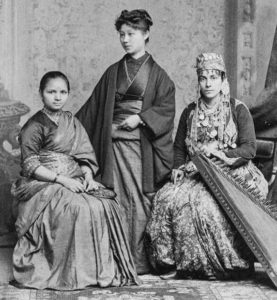 photo of three women in various types of dress