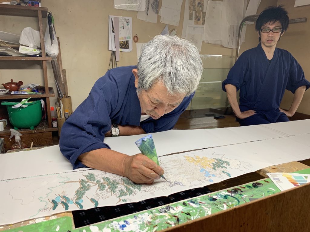 Kamachi Yutaka and his son, Kamachi Shota, who practice colored flour paste-resist dyeing for Chiso
