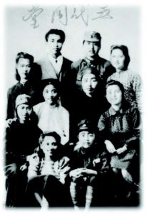 a black and white family portrait, faded.