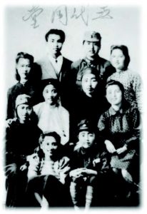 a black and white family portrait, faded. 