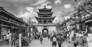 A Chinese Confucius temple and market place. Shoppers walk through the concourse. 