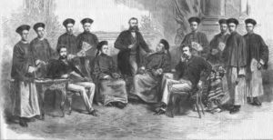 a painting of scholars sitting and standing together