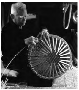 A man sitting on the floor for basket making