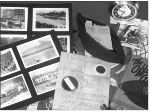 Photo of items on the table, such as a clock, some pictures and a book