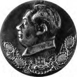 photo of a button with an engraved profile of a man