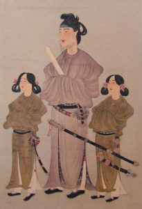 illustration of a man in a robe with a samurai sword, with two small robed women on each side of him. 